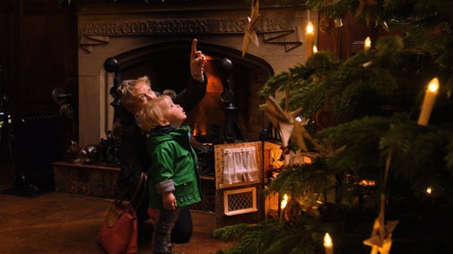 Little boy and grandmother looking at the Christmas tree at Scotney Castle